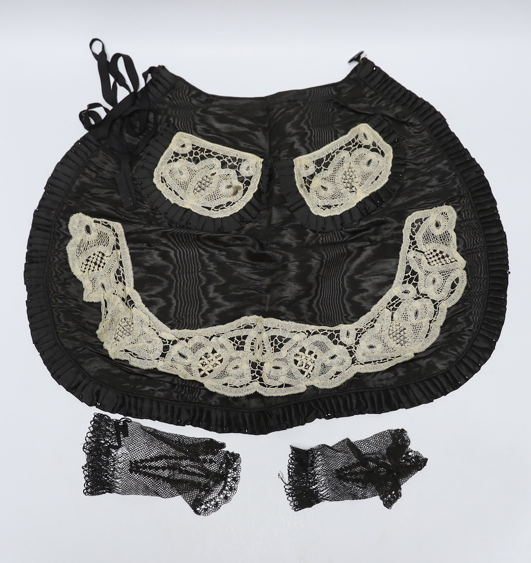 Two 19th century silk baby gowns, a ladies lace trimmed bonnet, a black satin and lace maids apron, various tatting tape lace and other table mats, etc.
